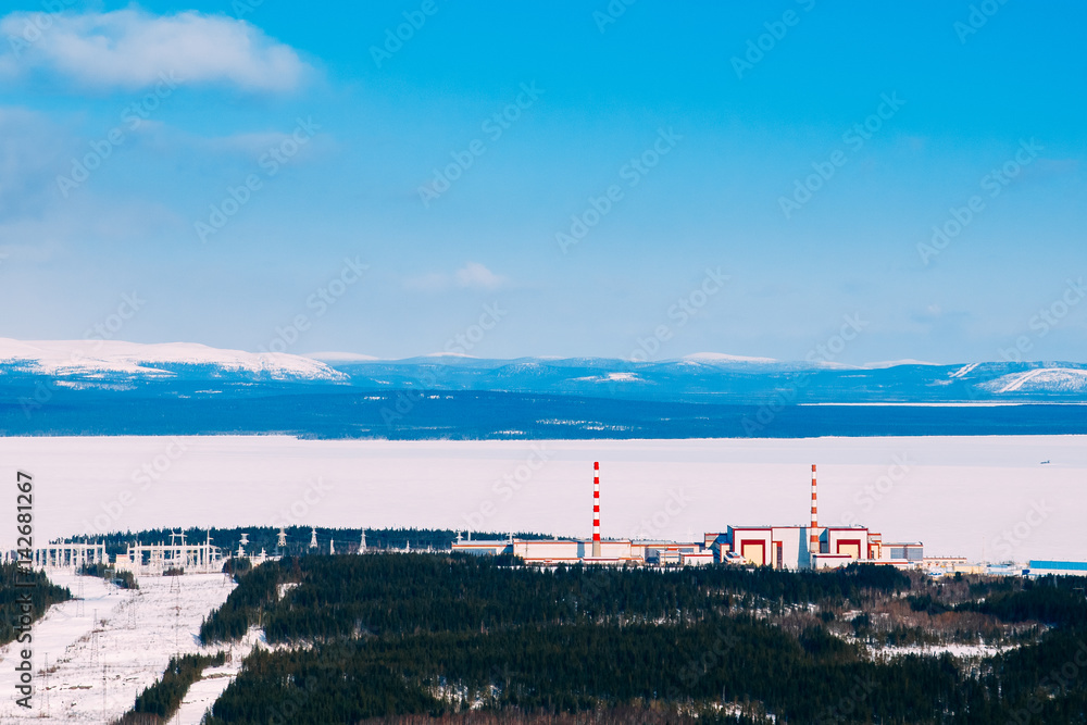Kola NPP  nuclear power station from the mountain. Industrial landscape. In the background are the mountains of Khibiny and Imandra lake.
