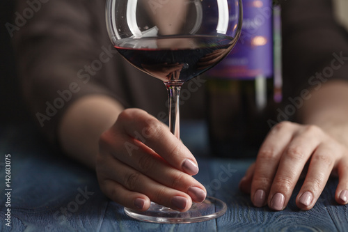 woman with glass of red wine closeup