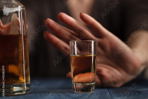 woman refused a glass of whiskey photo