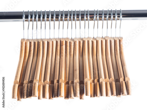 Wooden hanger on metal rail over white isolated background