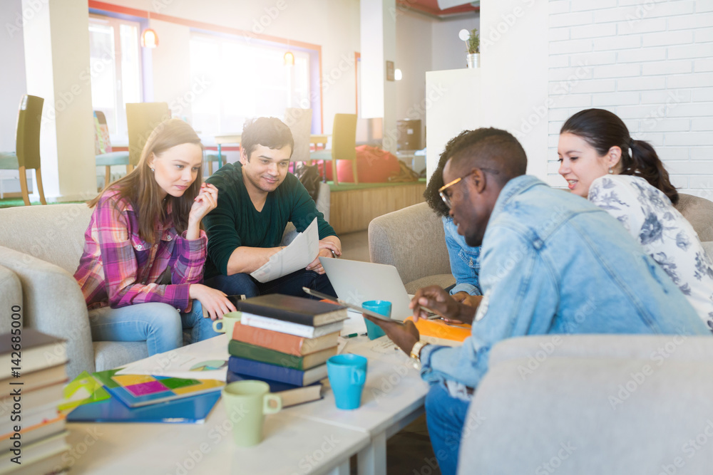 Happy young multiracial group of young university students studying Happy young multiracial group of young university students studying