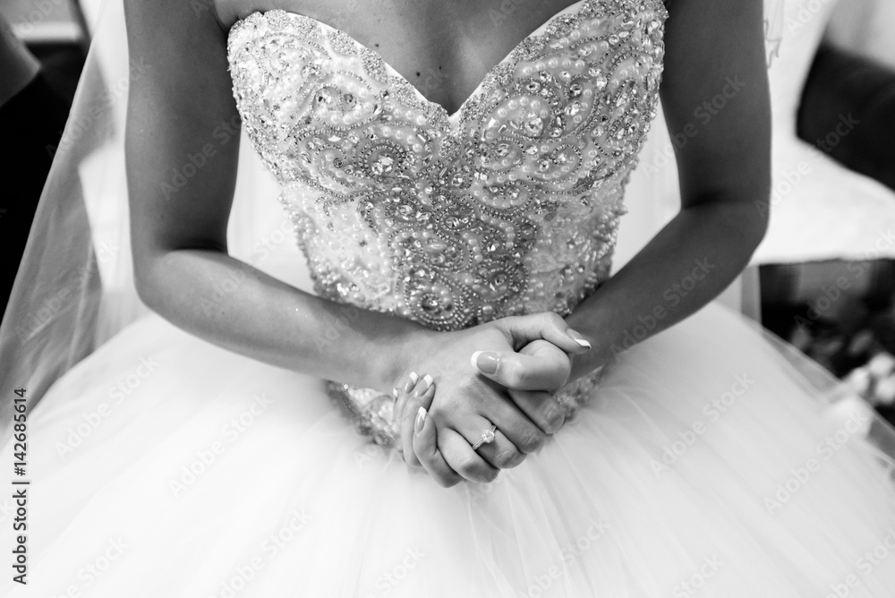 Bride's hands crossed on white dress Bride's hands crossed on white dress