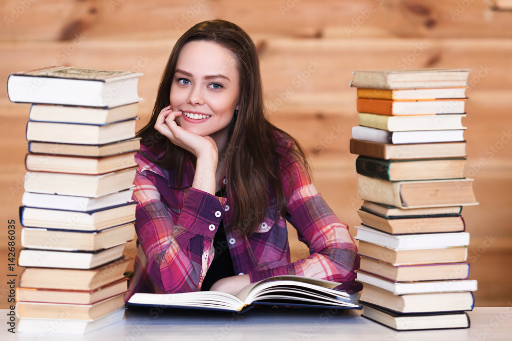 Beautiful young african american student girl with a lot of books and laptop Beautiful young african american student girl with a lot of books and laptop