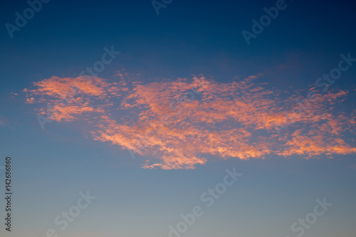 Pink clouds on blue sky