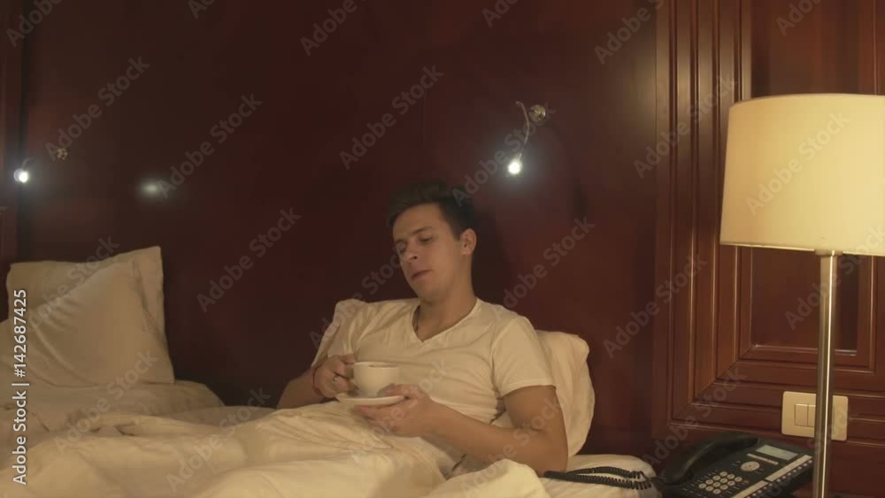 Handsome young man drinking coffee at home Handsome young man drinking coffee at home