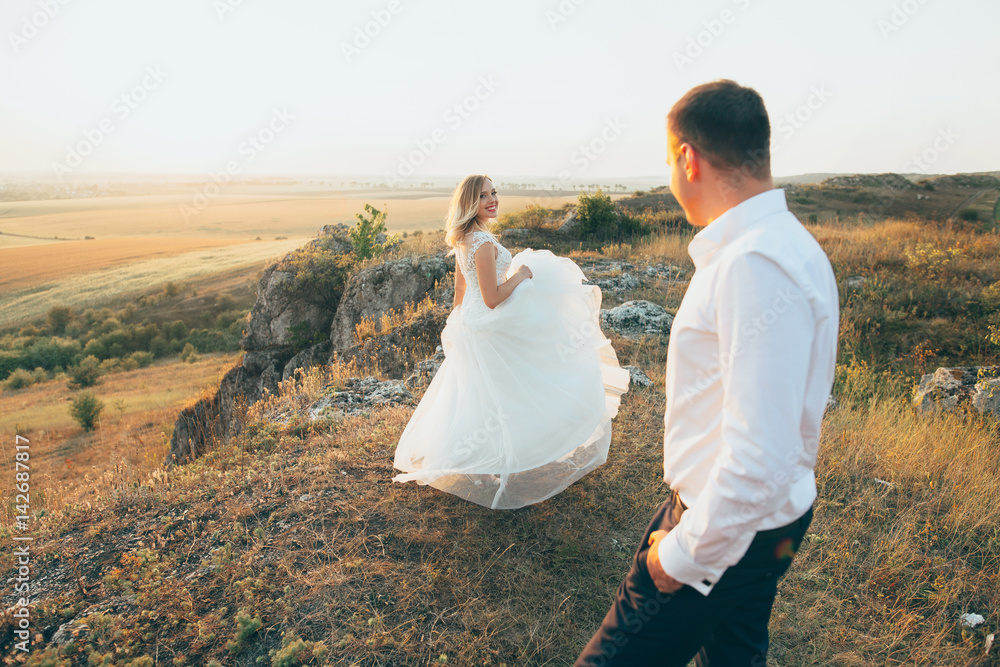 Bride and groom are walking at the mountains Bride and groom are walking at the mountains