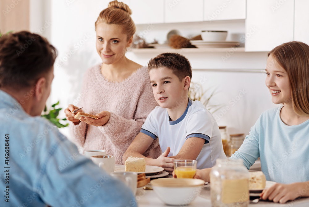 Positive children having breakfast with their parents Positive children having breakfast with their parents