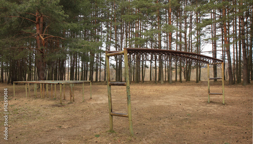 Fototapeta Naklejka Na Ścianę i Meble -  Metal simulators in a pine forest in Belarus