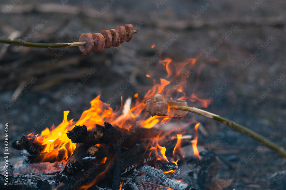 Cooking food at a campfire in the open air. Cooking food at a campfire in the open air.