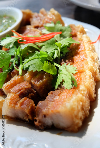 Deep fried pork belly serving with spicy dipping sauce