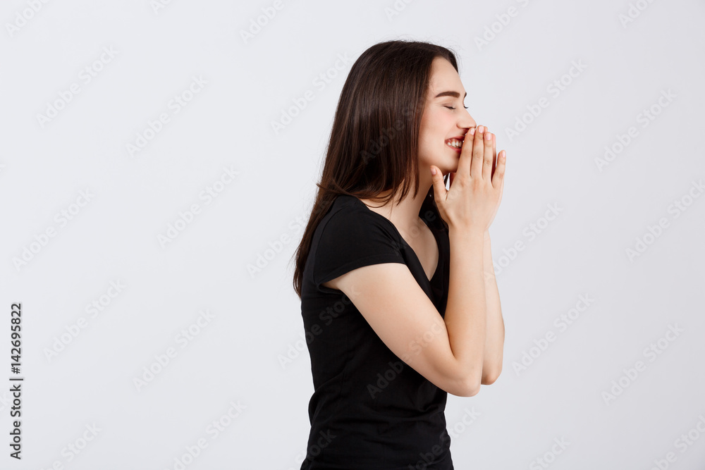 Young beautiful surprised girl in black t-shirt posing over white background Young beautiful surprised girl in black t-shirt posing over white background
