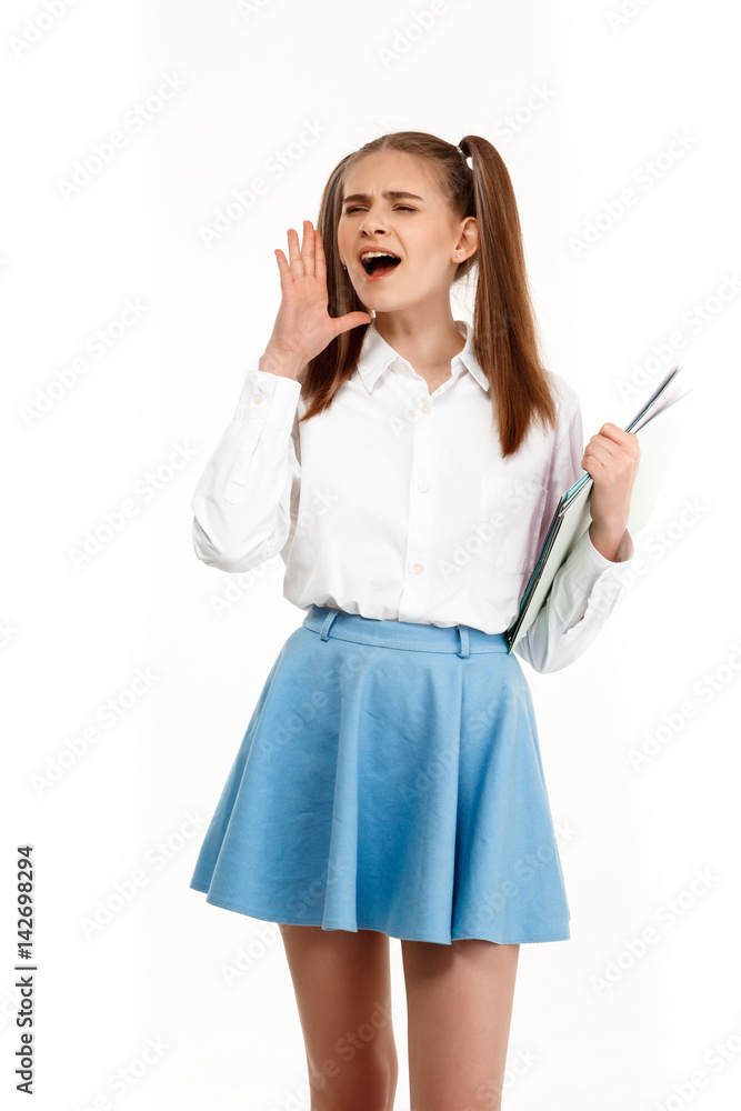 Young emotional girl in uniform posing, isolated on white background. Young emotional girl in uniform posing, isolated on white background.