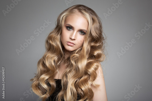 Portrait Of A Beautiful Young Blond Woman With Long Wavy Hair
