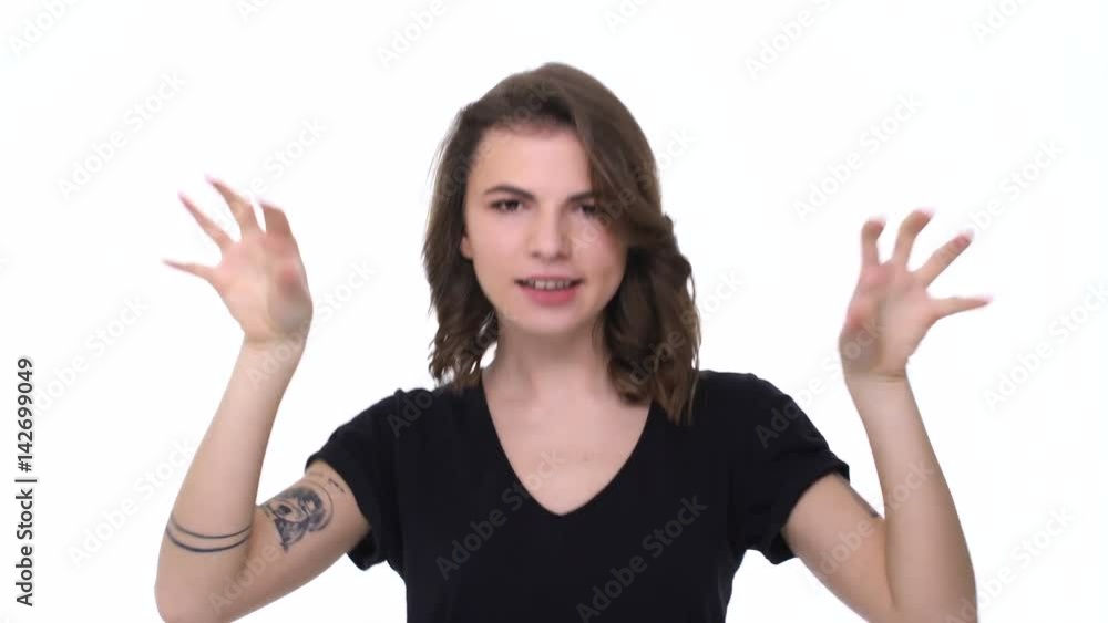 Pretty young excited teenage girl showing biceps isolated on the white background Pretty young excited teenage girl showing biceps isolated on the white background