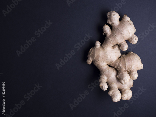 Fresh ginger root isolated on black background