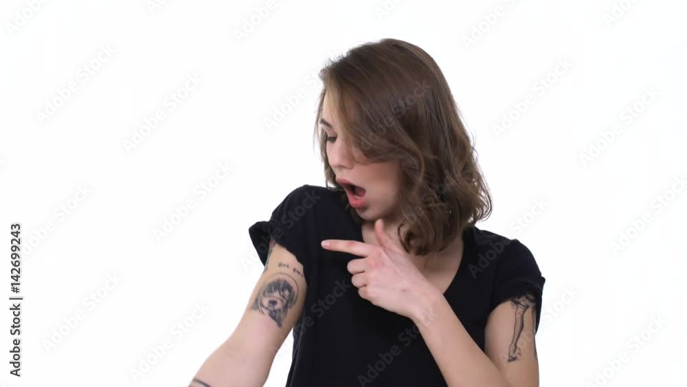 Prideful young teenage girl showing her tattoo and rock sign with tongue isolated Prideful young teenage girl showing her tattoo and rock sign with tongue isolated