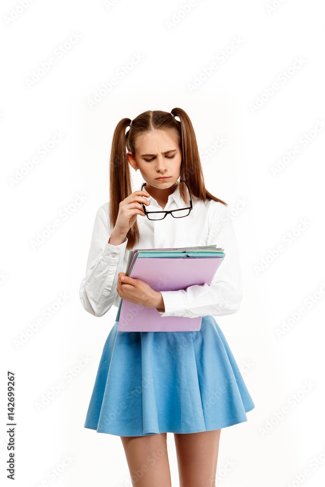 Young emotional girl in uniform posing, isolated on white background. Young emotional girl in uniform posing, isolated on white background.