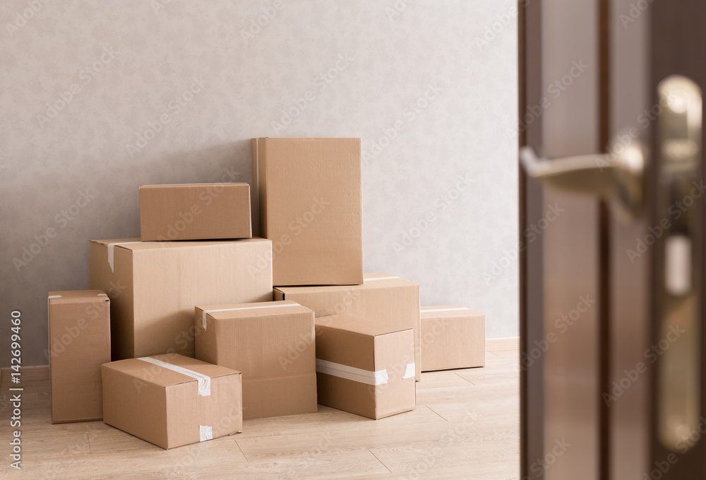 Moving boxes pile in doorway Moving boxes pile in doorway