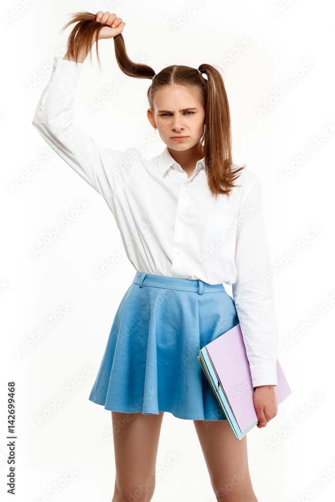 Young emotional girl in uniform posing, isolated on white background. Young emotional girl in uniform posing, isolated on white background.