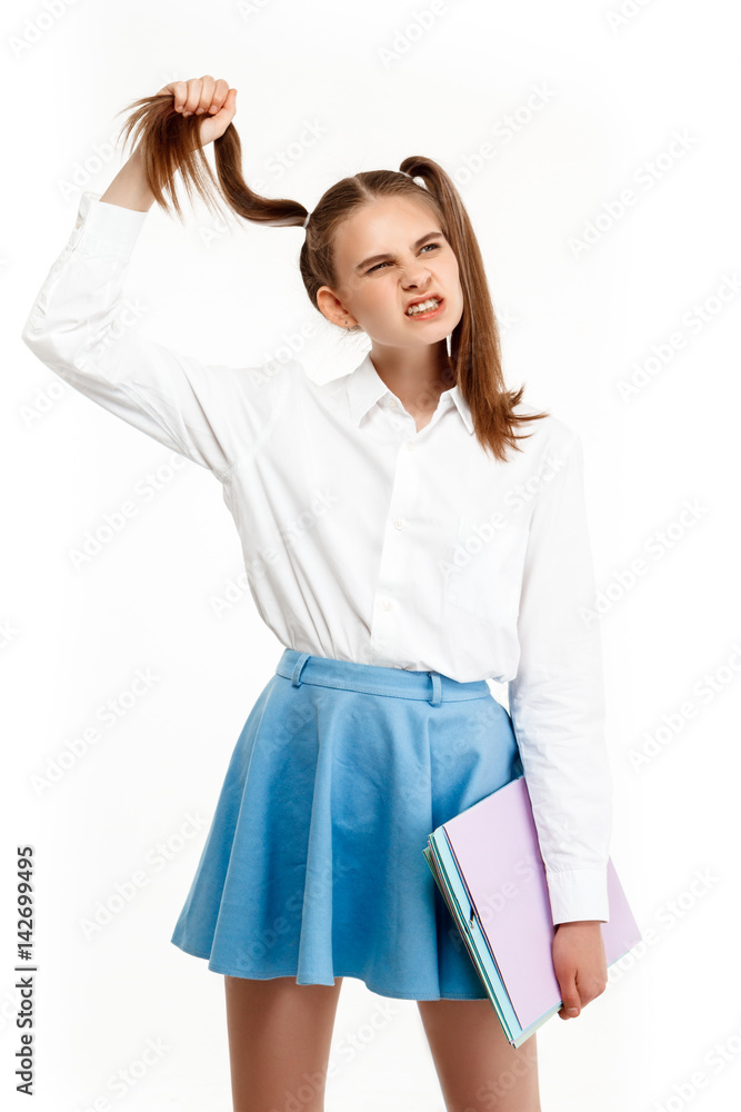 Young emotional girl in uniform posing, isolated on white background. Young emotional girl in uniform posing, isolated on white background.