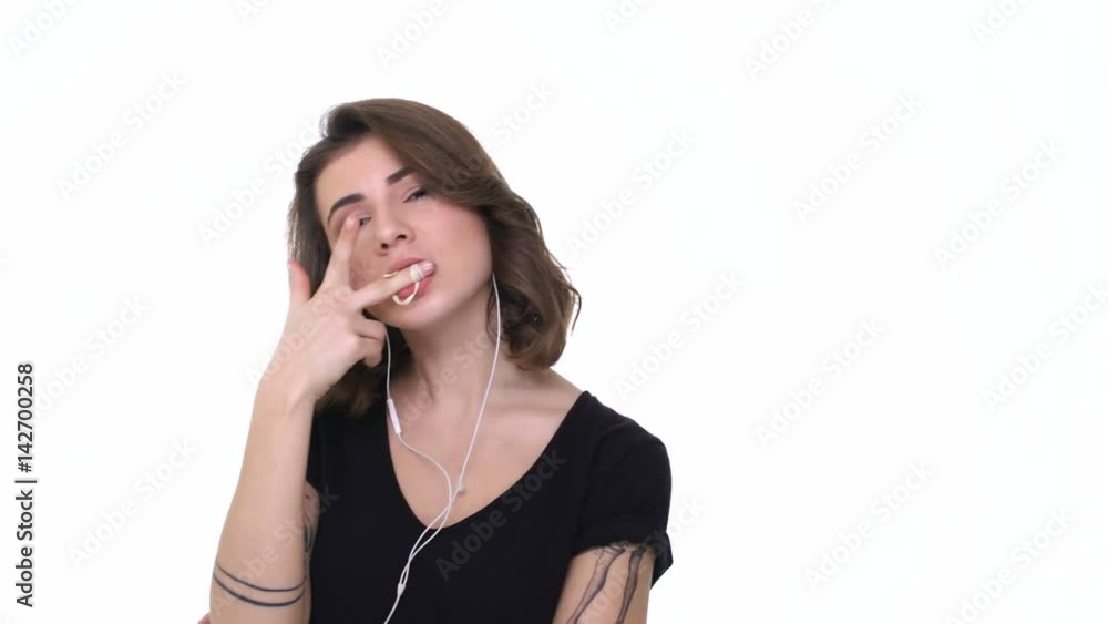 Young teenager girl in earphones chewing bubble gum isolated Young teenager girl in earphones chewing bubble gum isolated