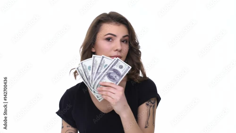 Young teenage girl burning money banknote with lighter isolated Young teenage girl burning money banknote with lighter isolated
