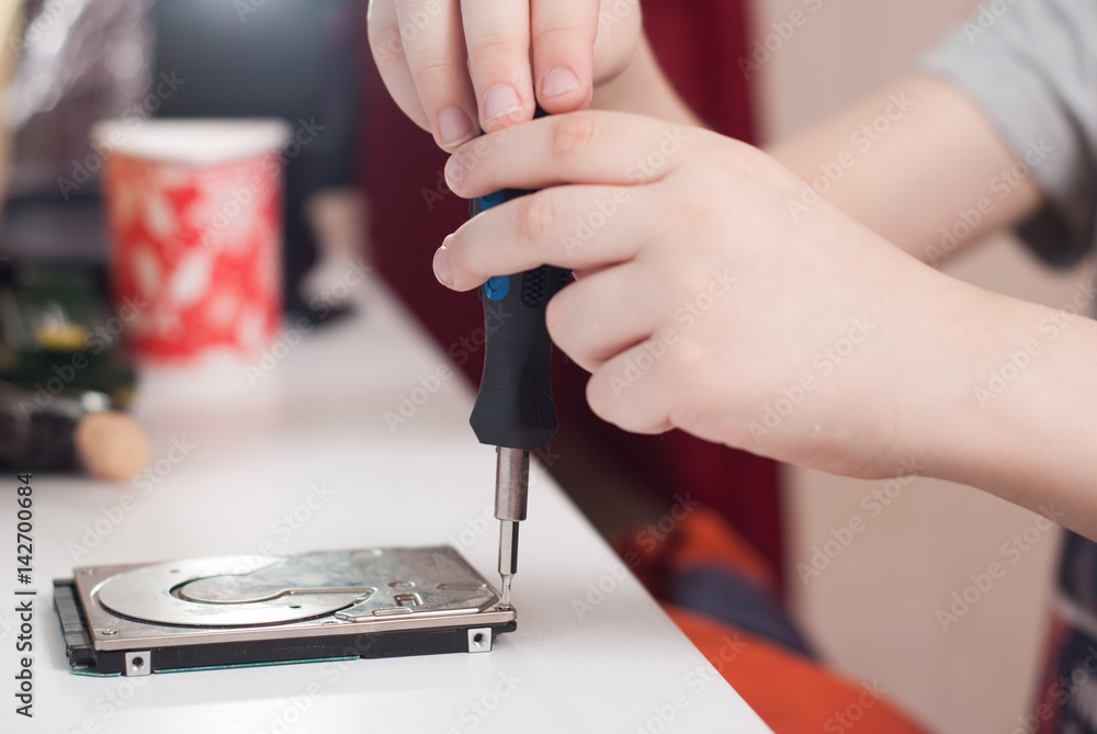 Hands of a little boy with the screwdriver, Hands of a little boy with the screwdriver,