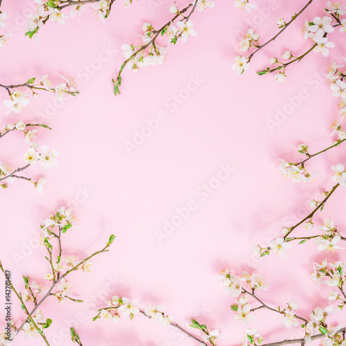 Frame of spring flowers on pink background. Flat lay  top view. Spring time background.