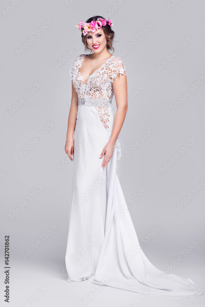 Beautiful young lady with a wreath in her hair and a lace wedding dress. Beautiful young lady with a wreath in her hair and a lace wedding dress.