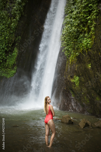 Fototapeta Naklejka Na Ścianę i Meble -  Beautiful woman in red bikini and waterfall.