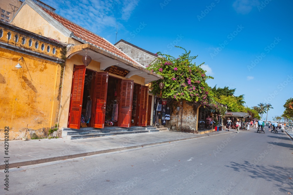 HOI AN, VIETNAM - MARCH 15, 2017: Ancient street view on a nice day HOI AN, VIETNAM - MARCH 15, 2017: Ancient street view on a nice day