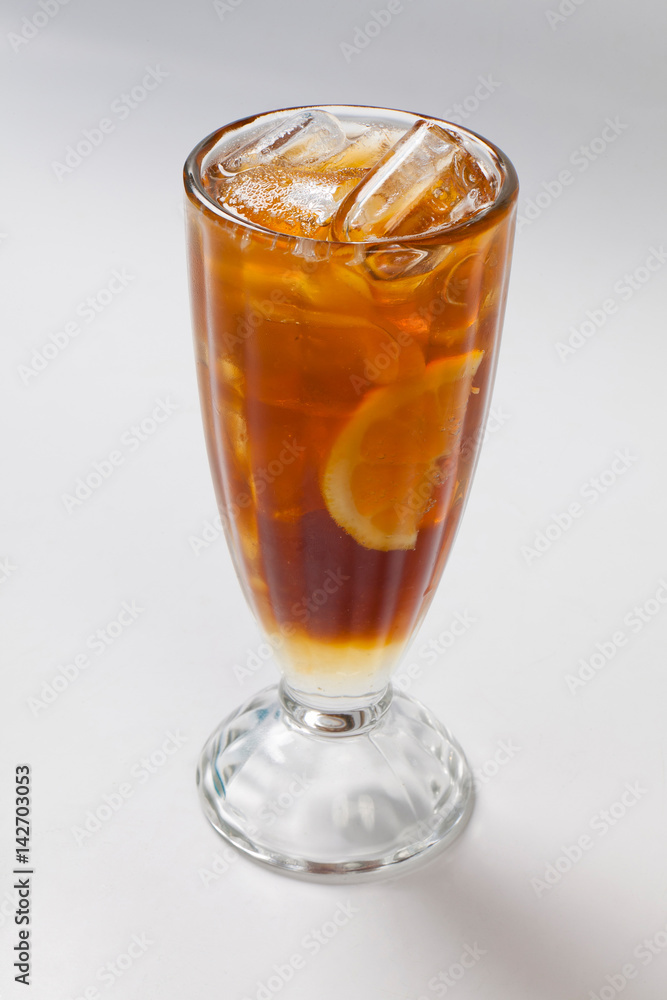 cold tea with lemon and ice in the glass. cold tea with lemon and ice in the glass.