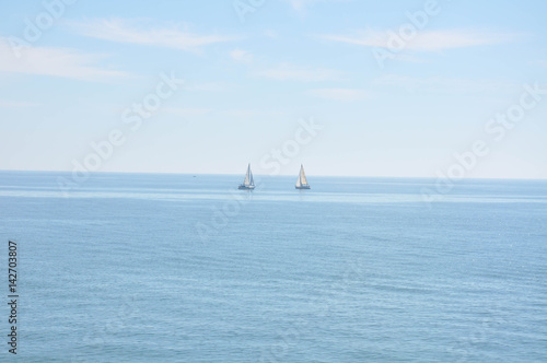 Yachts and boats sailing along the calm water of the Mediterranean Sea during the day