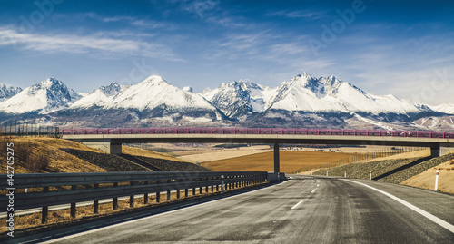 Obraz na plátně Empty highway and Tatra mountains, Slovakia