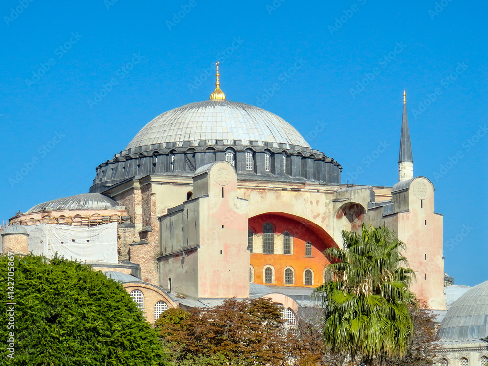 The colourful Hagia Sofia against clear blue sky. It was formerly a christian church, but is now a mosque and a museum in Istanbul.