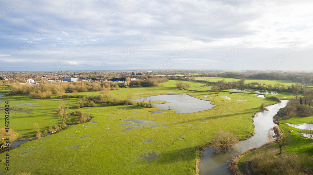 Aerial view of a lake and river area in the countryside late afternoon in the winter