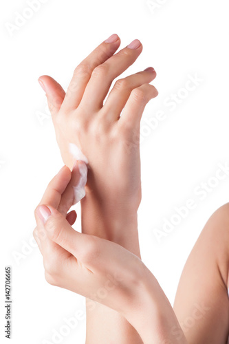 Perfect soft hands on isolated background with the drop of moisturizing cream on. young girl wearing hand cream