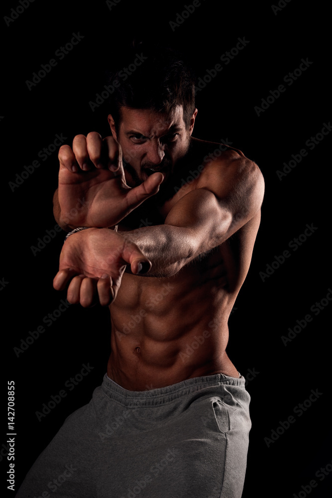 Sexy young man shirtless showing his strength Sexy young man shirtless showing his strength