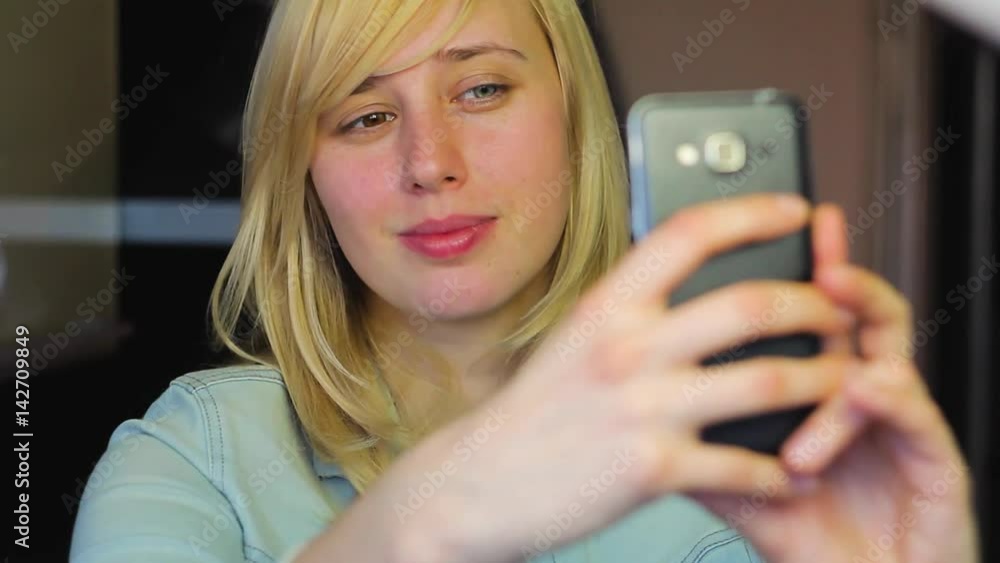 European blonde Girl With different eyes takes selfie on phone, heterochromia European blonde Girl With different eyes takes selfie on phone, heterochromia