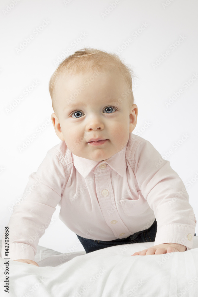 Close-up portrait of cute 9-month-old toddler looking at camera. Adorable crawling infant kid. Close-up portrait of cute 9-month-old toddler looking at camera. Adorable crawling infant kid.