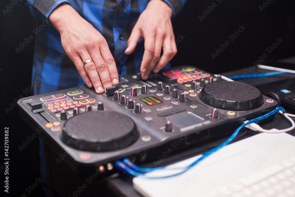 DJ mixing music on console at the night club DJ mixing music on console at the night club
