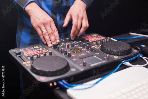 DJ mixing music on console at the night club