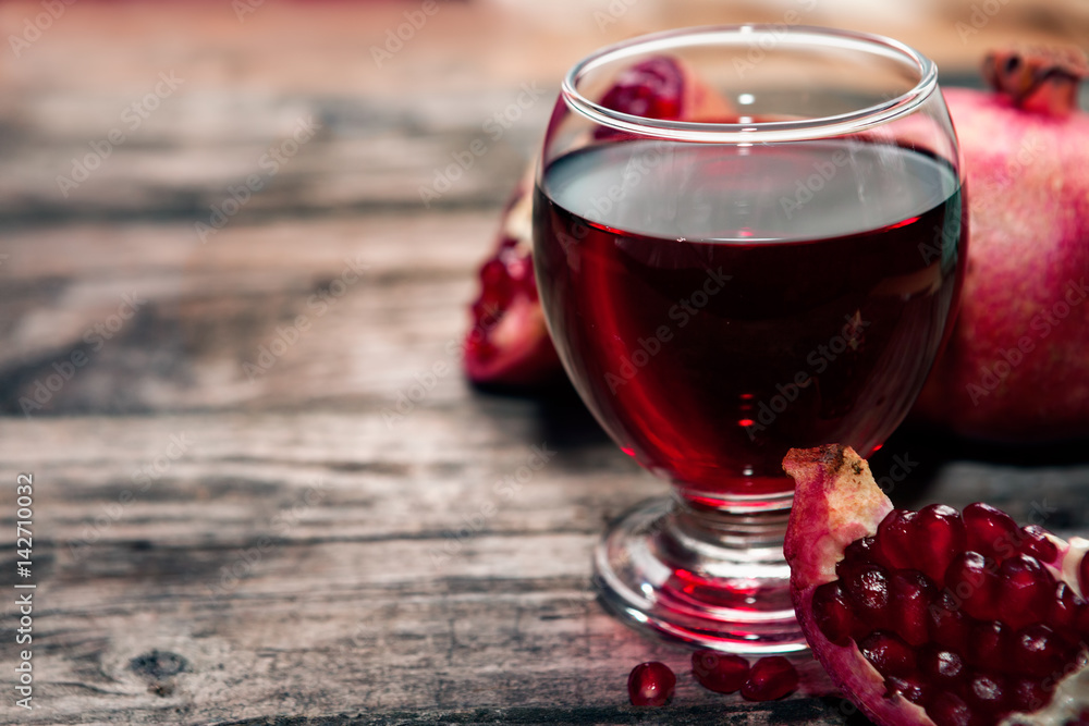 Glass with pomegranate juice on the table Glass with pomegranate juice on the table