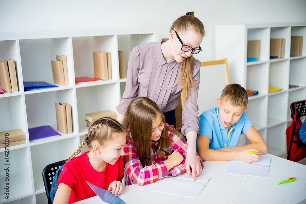 Teacher helping students