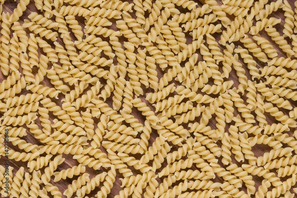 Raw macaroni on a wooden background. Mix pasta. Close up Raw macaroni on a wooden background. Mix pasta. Close up