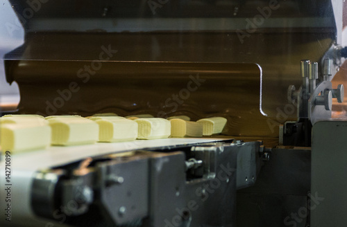 Glazed syrki with chocolate on the conveyor photo