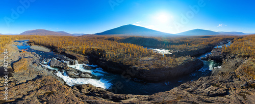 Aerial panorama of the autumn mountains landscape. Waterfall in the National park Putorana in Siberia. Nature and ecology concept. © Alexey Yuzhakov