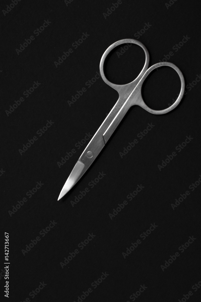 Scissors for manicure woman nails on a black background. tools Scissors for manicure woman nails on a black background. tools