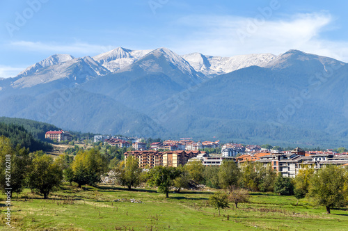Beautiful view of the Bansko. Snow covered peaks of the Pirin mountains on background - Pirin National Park, Bulgaria photo