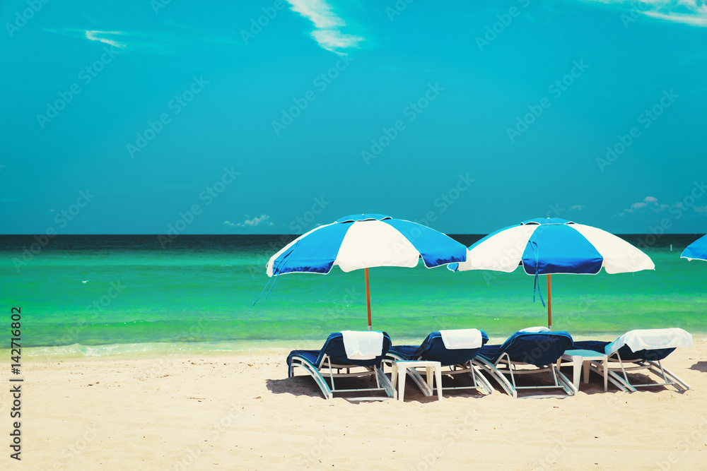 chairs on tropical sand beach
